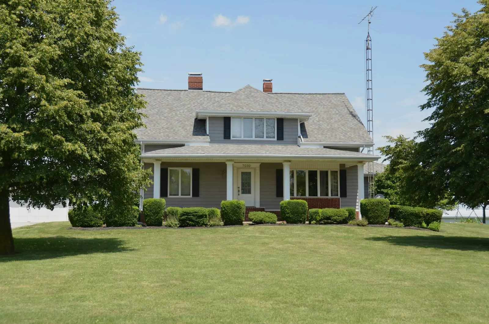 Stately grey home with replaced architectural shingles